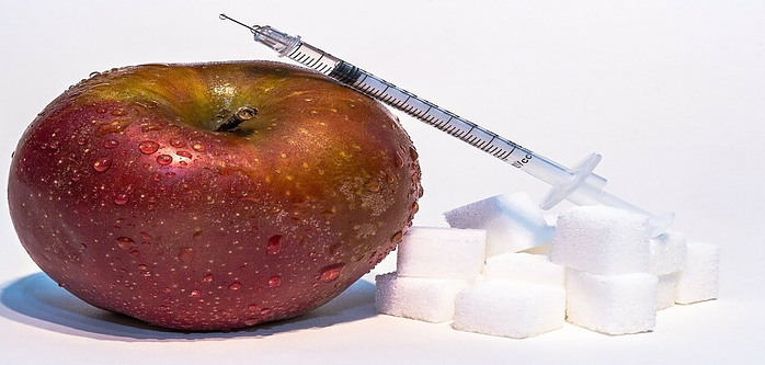 Apple with sugar cubes and syringe